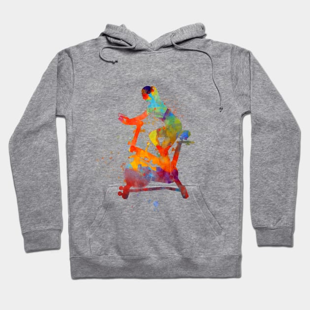 woman riding an exercise spin bike in the gym Hoodie by PaulrommerArt